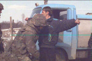 UN soldier searching a civilian for handguns.